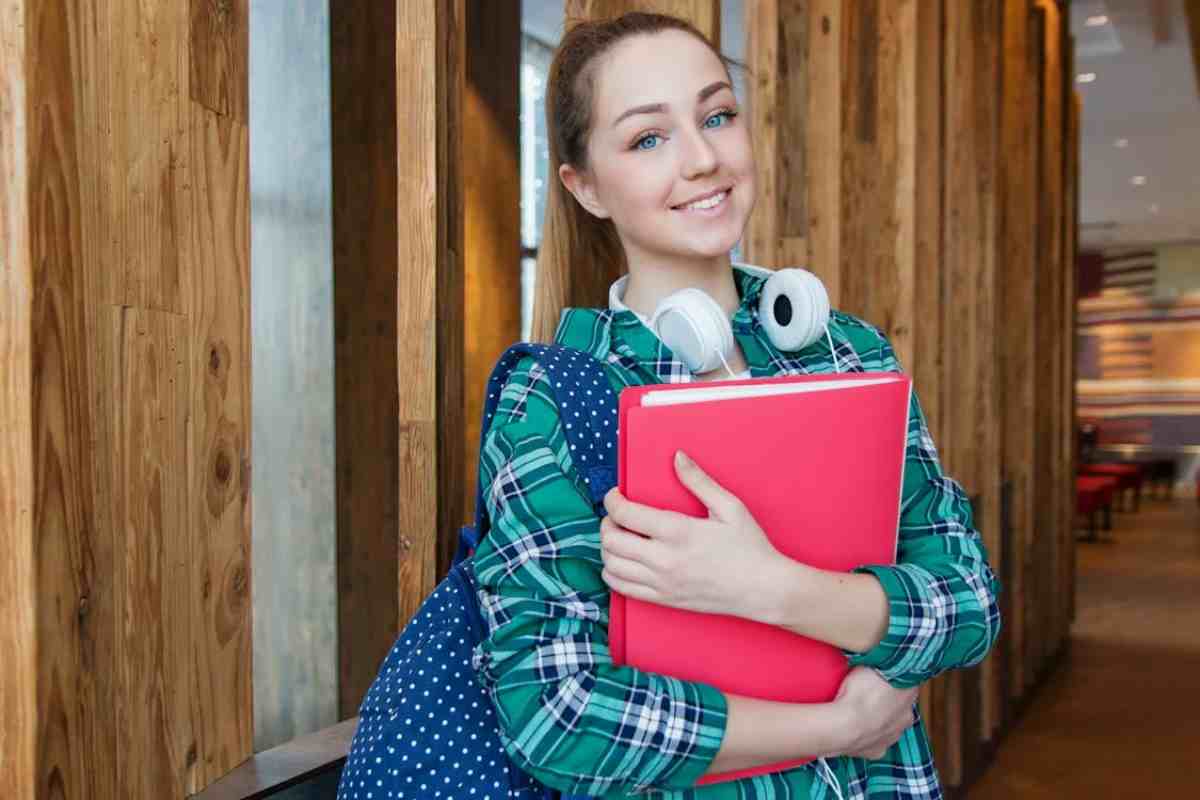 Studentessa felice con libri in mano