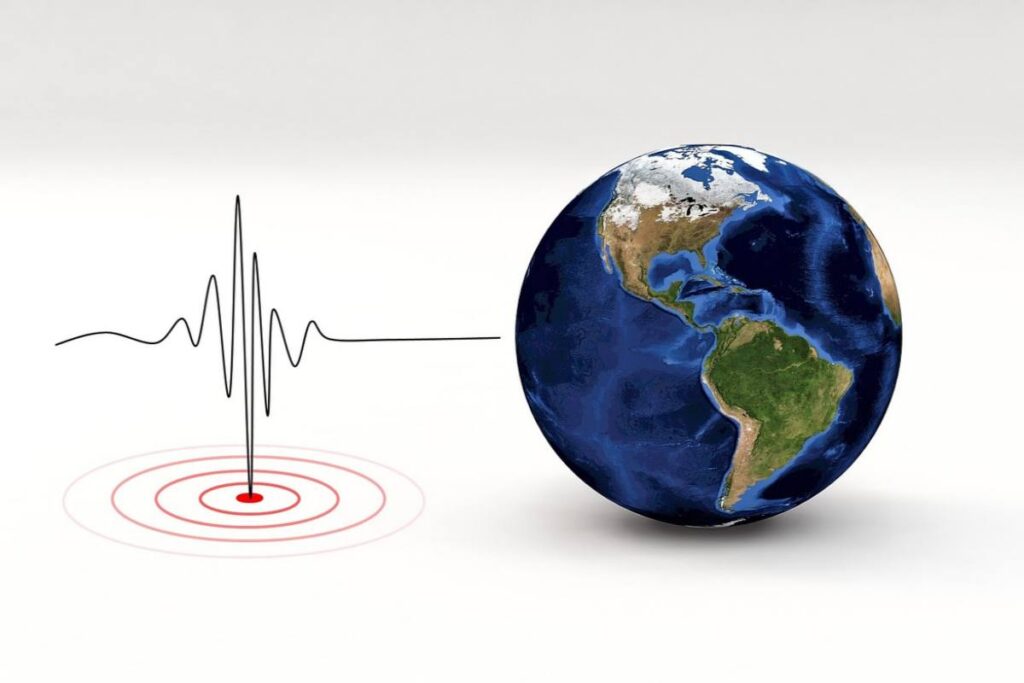 sismografo con accanto il globo terrestre